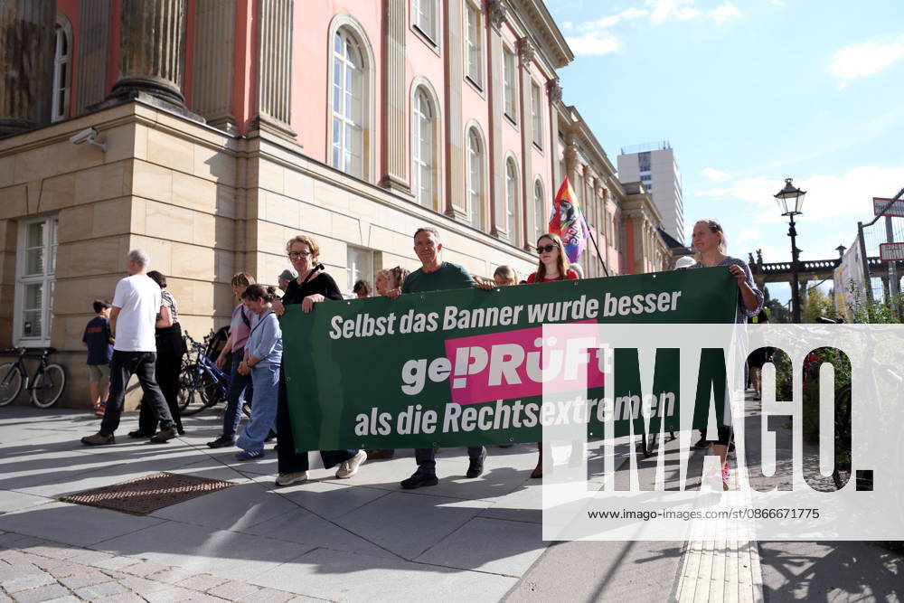 Protesters march with a banner. Even the banner was scrutinized more closely than the far-right extremists as they gathered around the state parliament during a demonstration calling for the Federal Constitutional Court to review far-right parties, Alter Markt, Potsdam, September 12, 2026. Protest in Potsdam