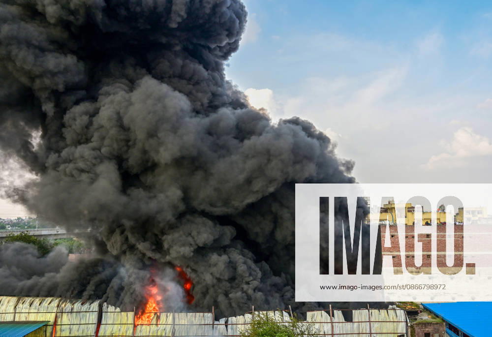 A fire breaks out at a plywood warehouse in Dallupura, East Delhi, sending thick smoke into the sky that is visible from several kilometres away, on September 13, 2026 in New Delhi, India. The fire department received a call about the blaze at 3.20 pm, following which 12 fire tenders were rushed to the spot. Firefighters were present at the site and were working to control the blaze. (Photo by Sunil Ghosh Hindustan Times ) Massive Fire Breaks Out At Delhi Plywood Warehouse, 12 Fire Tenders Rushed