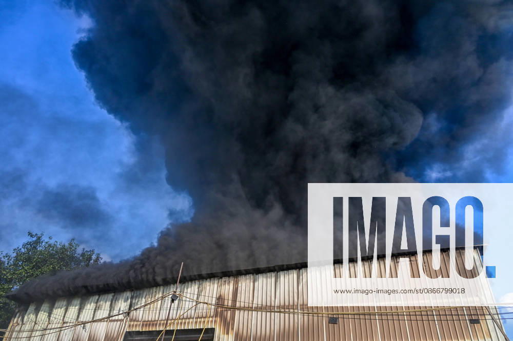 Firefighters work to extinguish a massive blaze at a plywood warehouse in Dallupura, East Delhi, as thick plumes of smoke billow into the sky and remain visible from several kilometres away, on September 13, 2026 in New Delhi, India. The fire department received a call about the blaze at 3.20 pm, following which 12 fire tenders were rushed to the spot. Firefighters were present at the site and were working to control the blaze. (Photo by Sunil Ghosh Hindustan Times ) Massive Fire Breaks Out At Delhi Plywood Warehouse, 12 Fire Tenders Rushed