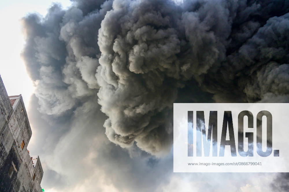 Firefighters work to extinguish a massive blaze at a plywood warehouse in Dallupura, East Delhi, as thick plumes of smoke billow into the sky and remain visible from several kilometres away, on September 13, 2026 in New Delhi, India. The fire department received a call about the blaze at 3.20 pm, following which 12 fire tenders were rushed to the spot. Firefighters were present at the site and were working to control the blaze. (Photo by Sunil Ghosh Hindustan Times ) Massive Fire Breaks Out At Delhi Plywood Warehouse, 12 Fire Tenders Rushed