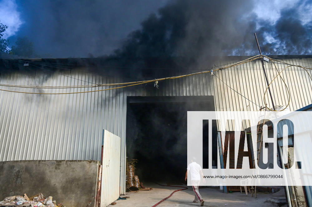 Firefighters work to extinguish a massive blaze at a plywood warehouse in Dallupura, East Delhi, as thick plumes of smoke billow into the sky and remain visible from several kilometres away, on September 13, 2026 in New Delhi, India. The fire department received a call about the blaze at 3.20 pm, following which 12 fire tenders were rushed to the spot. Firefighters were present at the site and were working to control the blaze. (Photo by Sunil Ghosh Hindustan Times ) Massive Fire Breaks Out At Delhi Plywood Warehouse, 12 Fire Tenders Rushed