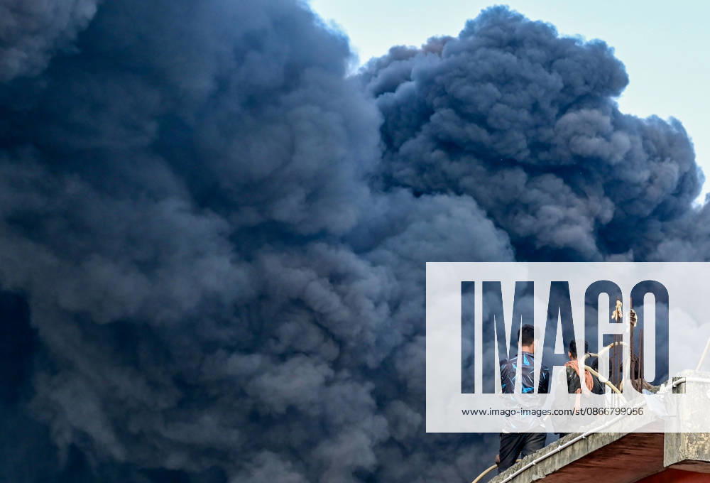 Firefighters work to extinguish a massive blaze at a plywood warehouse in Dallupura, East Delhi, as thick plumes of smoke billow into the sky and remain visible from several kilometres away, on September 13, 2026 in New Delhi, India. The fire department received a call about the blaze at 3.20 pm, following which 12 fire tenders were rushed to the spot. Firefighters were present at the site and were working to control the blaze. (Photo by Sunil Ghosh Hindustan Times ) Massive Fire Breaks Out At Delhi Plywood Warehouse, 12 Fire Tenders Rushed