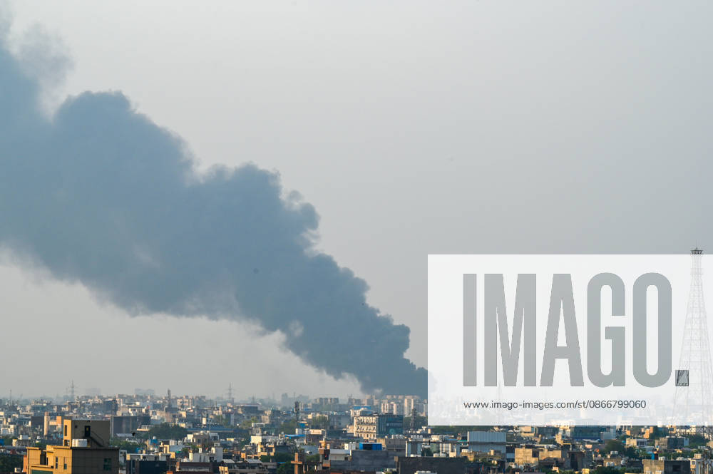 A fire breaks out at a plywood warehouse in Dallupura, East Delhi, sending thick smoke into the sky that is visible from several kilometres away, on September 13, 2026 in New Delhi, India. The fire department received a call about the blaze at 3.20 pm, following which 12 fire tenders were rushed to the spot. Firefighters were present at the site and were working to control the blaze. (Photo by Sunil Ghosh Hindustan Times ) Massive Fire Breaks Out At Delhi Plywood Warehouse, 12 Fire Tenders Rushed