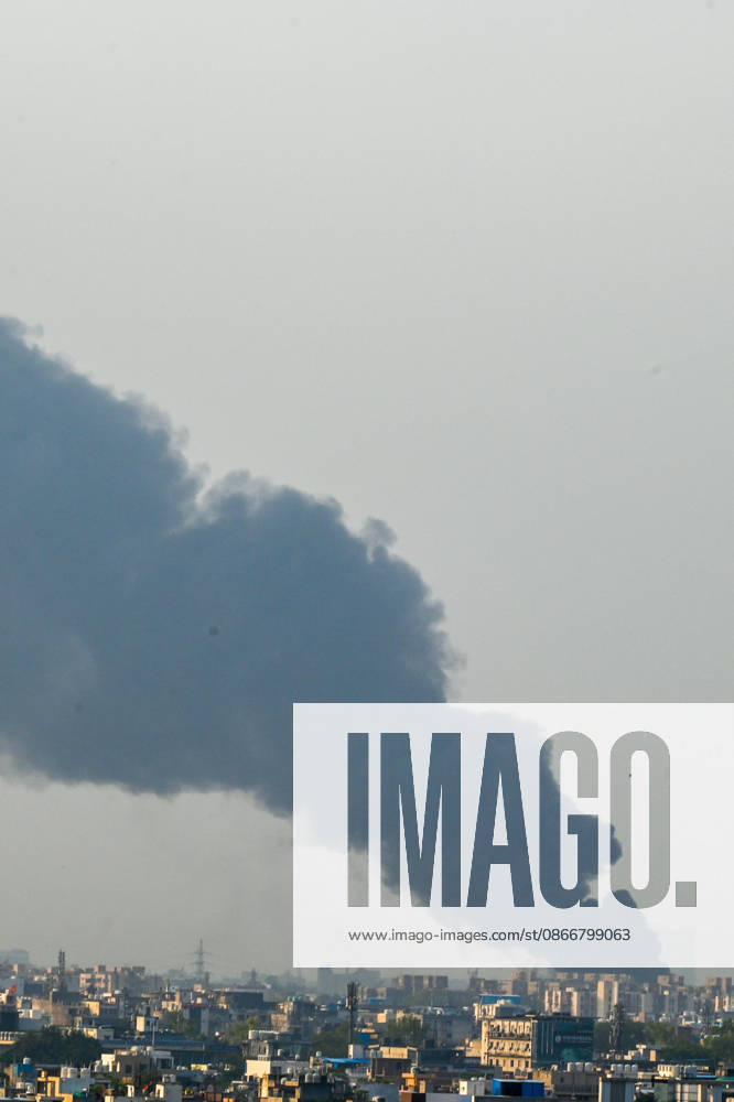 A fire breaks out at a plywood warehouse in Dallupura, East Delhi, sending thick smoke into the sky that is visible from several kilometres away, on September 13, 2026 in New Delhi, India. The fire department received a call about the blaze at 3.20 pm, following which 12 fire tenders were rushed to the spot. Firefighters were present at the site and were working to control the blaze. (Photo by Sunil Ghosh Hindustan Times ) Massive Fire Breaks Out At Delhi Plywood Warehouse, 12 Fire Tenders Rushed