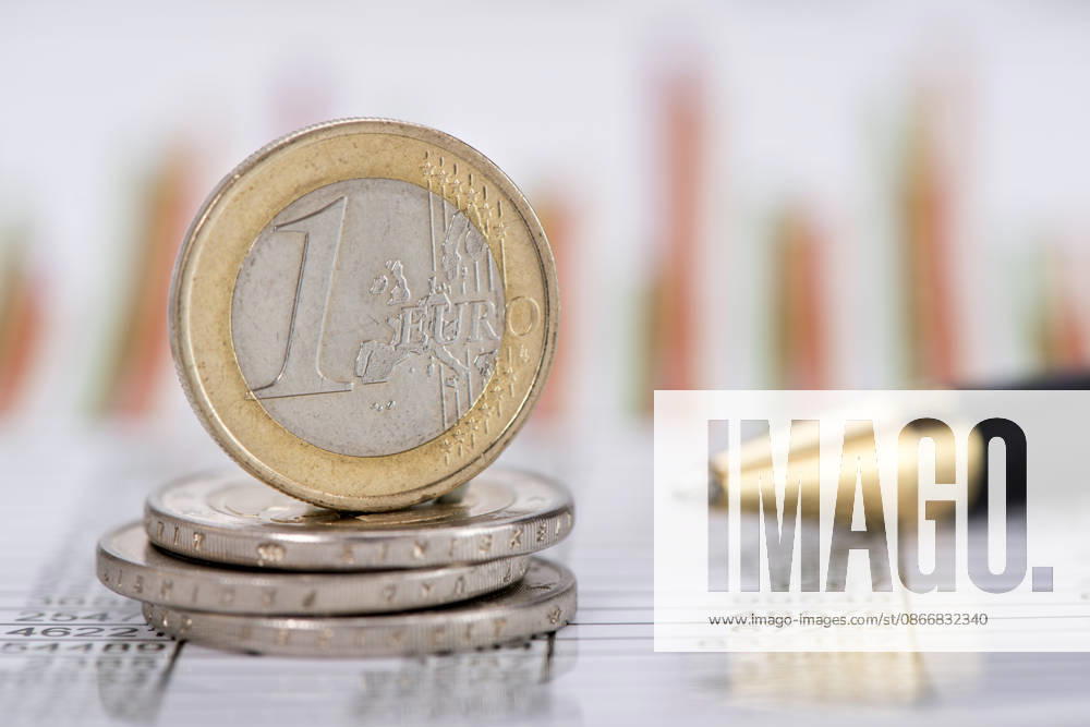 Close-up of a Euro Coin: A single Euro coin is shown in close-up on a stock market chart. FOR