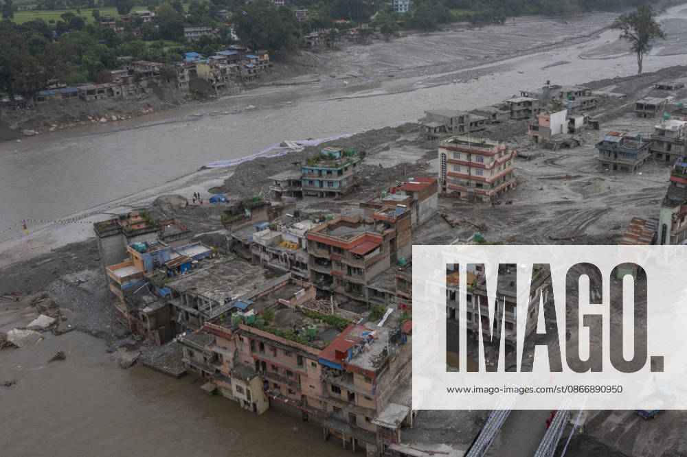 Aftermath of the devastating flash floods in Nepal NUWAKOT, NEPAL - SEPTEMBER 15: A view of the submerged landscape following the devastating flash floods on August 26 that struck Devighat, Nuwakot, Nepal, on September 15, 2026. People in the affected areas of Nuwakot continue to return in search of their destroyed homes and the last remaining memories of their lives. Some are trying to recover essential belongings from the rubble, while others are working with family members to remove soil from parts of their homes buried underground and make them habitable again. The destruction in Devighat village is severe. Many multi-storey buildings have collapsed, while some have been buried under earth up to the level of their fifth floors. Religiou