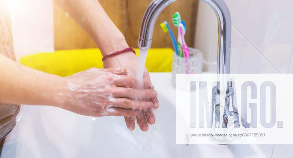 Close up washing hands in the bathroom. Prevention against flu or corona.