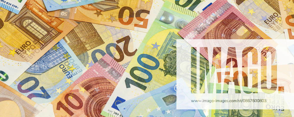 Euro Banknotes: A large number of euro bills and banknotes are piled together, serving as a symbolic image of a strong euro currency. FOR