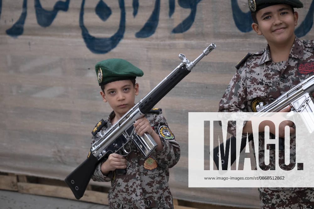 Opening Ceremony Of Second City-Square Military Training Camp Two Iranian schoolboys wearing military uniforms hold rifles during the opening ceremony of the second city-square military training camp for self-sacrificing forces in downtown Tehran, Iran, on October 3, 2026. The camp was established by the Basij paramilitary force, with personnel from the Islamic Republic of Iran Army responsible for training the volunteers. Tehran Tehran Iran