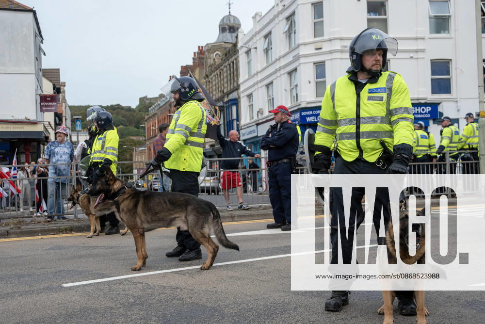 Members of the police dog unit with their German Shepherds keep clear the road during a demonstration in Dover. Supporters of the English Defence League (EDL) gathered in Dover, UK to march through the town all the way to the harbour. English Defence League is an extreme far-right and Islamophobic organisation. It was founded by Tommy Robinson (pseudonym of Steven Yaxley-Lennon) in 2009. Dover United Kingdom - ZUMAs197 20261003_aaa_s197_262