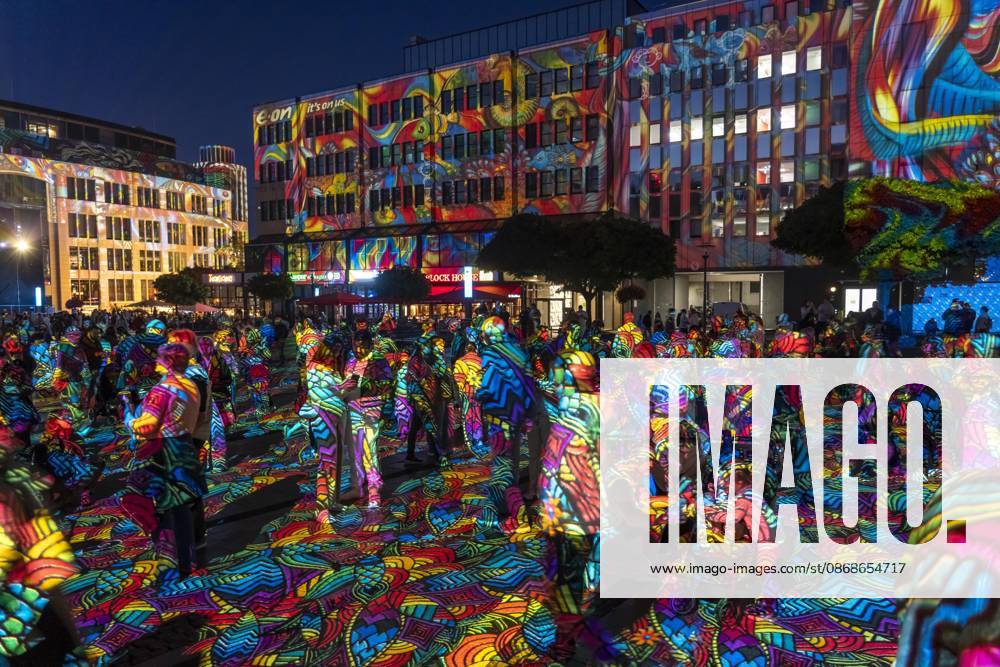 Essen Light Festival, in the city center; the light installation Diving in the Sea of Colors by Berlin-based artist Daniel Margraf illuminates the buildings on the large Kennedy Platz; visitors become part of the light art installation; North Rhine-Westphalia, Germany; Essen Light Festival