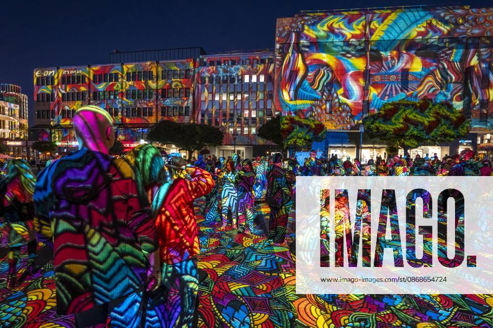 Essen Light Festival, in the city center; the light installation Diving in the Sea of Colors by Berlin-based artist Daniel Margraf illuminates the buildings on the large Kennedy Platz; visitors become part of the light art installation; North Rhine-Westphalia, Germany; Essen Light Festival