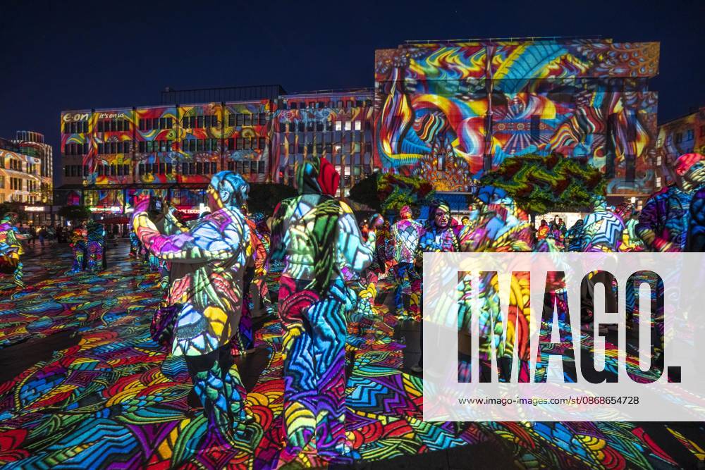 Essen Light Festival, in the city center; the light installation Diving in the Sea of Colors by Berlin-based artist Daniel Margraf illuminates the buildings on the large Kennedy Platz; visitors become part of the light art installation; North Rhine-Westphalia, Germany; Essen Light Festival