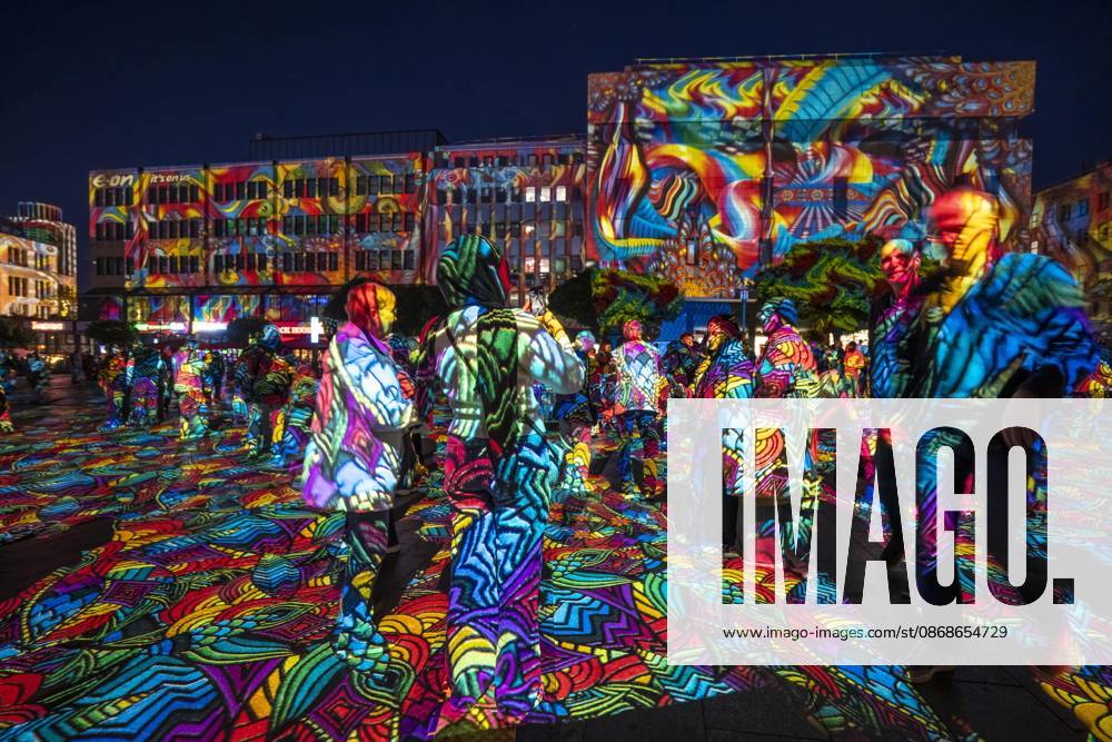 Essen Light Festival, in the city center; the light installation Diving in the Sea of Colors by Berlin-based artist Daniel Margraf illuminates the buildings on the large Kennedy Platz; visitors become part of the light art installation; North Rhine-Westphalia, Germany; Essen Light Festival