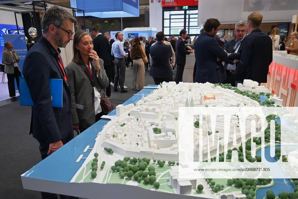 EXPO REAL 2026 is currently taking place at the Messe München exhibition grounds. It is Europe s largest international trade fair for real estate, investment, and infrastructure. Photo: Visitors are looking at a model at an exhibition booth.
