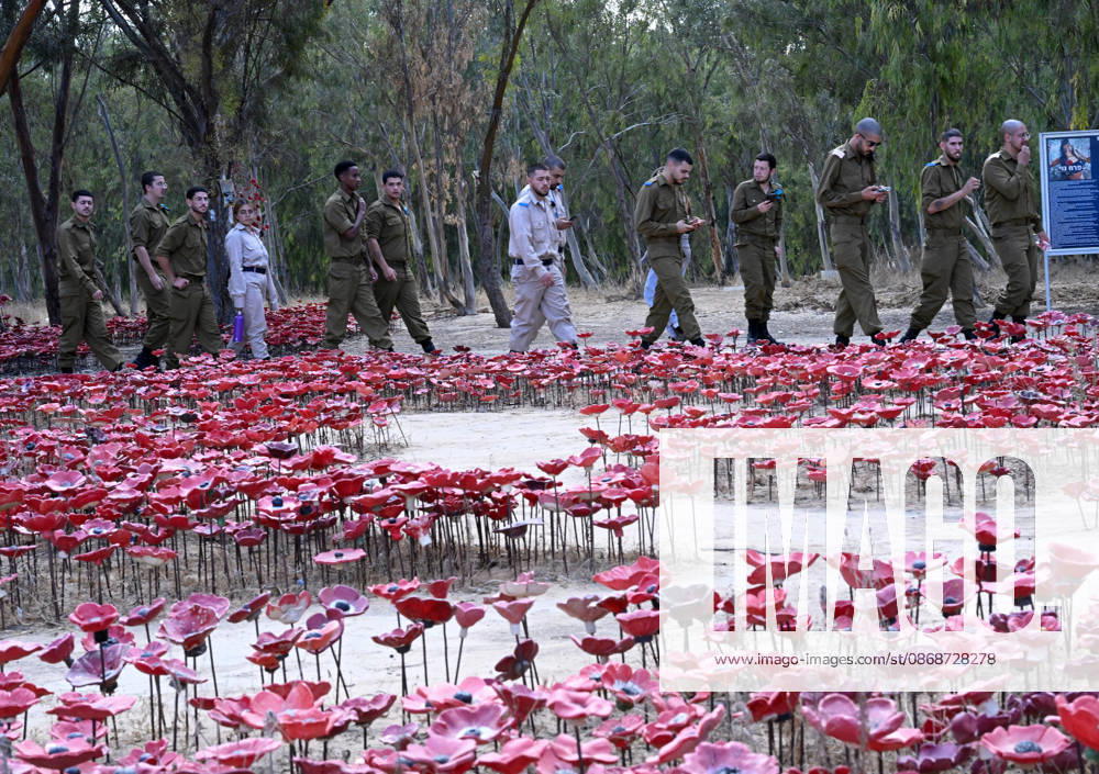 Israeli soldiers walk past an installation of red poppies in remembrance to the hundreds of victims killed by Hamas on October 7, 2023, at the Nova Festival Memorial site in Re im, near the Gaza border on Monday, October 6, 2026. Israel is marking three years since the Hamas attack that killed 1,200 people and 251 were taken hostage into Gaza. JER2026100614 DEBBIExHILL