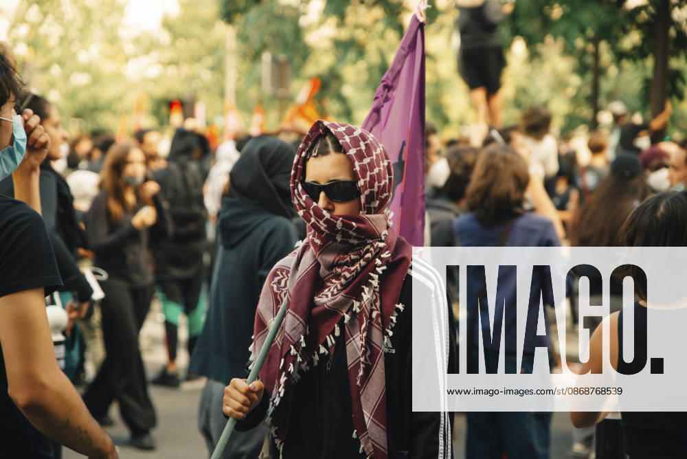 Paris Students Protest Education Conditions A demonstrator wearing sunglasses and a patterned scarf stands in a crowd beside a purple flag in Paris, France, on October 6, 2026. France s Interior Ministry said 256,000 people marched nationwide, including 56,000 in Paris, during the student-led day of action over school conditions. High school students called for more education funding and staff, smaller classes and improved facilities, with teachers, parents and unions joining demonstrations. Paris Ile de France France