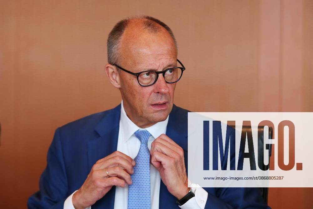 Berlin, Germany, October 7, 2026, Federal Chancellery, 61st Cabinet Meeting: Federal Chancellor Friedrich Merz (CDU) adjusts his tie at the start of the meeting