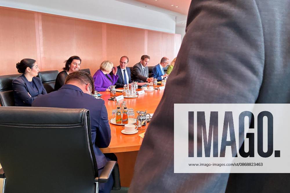 Berlin, Germany, October 7, 2026, Federal Chancellery, 61st Cabinet Meeting: Federal Chancellor Friedrich Merz (CDU) and his cabinet at the start of the meeting. A security guard stands in the foreground and pushes the photographers out of the room.
