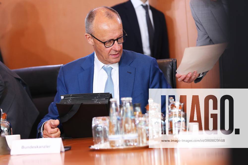 Berlin, Germany, October 7, 2026, Federal Chancellery, 61st Cabinet Meeting: Federal Chancellor Friedrich Merz (CDU) is shown a document