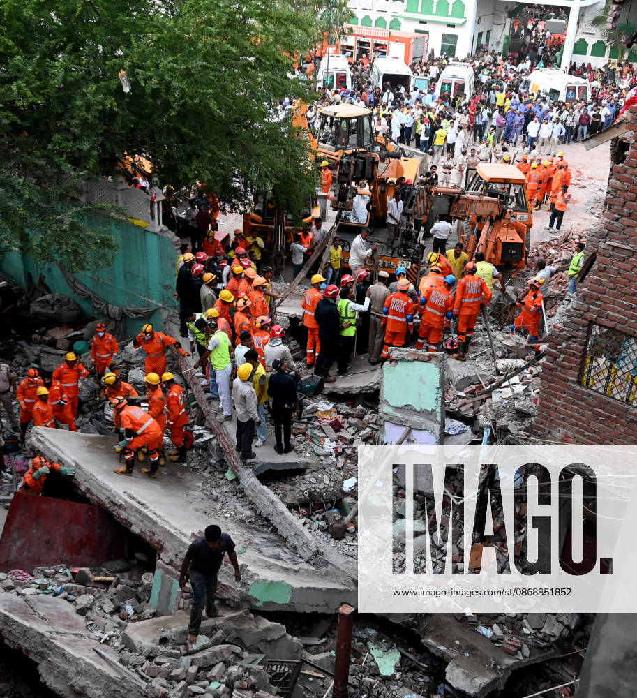 National Disaster Response Force (NDRF) jawans, Delhi Fire Service personnel, and local residents navigate heavy rubble during a search and rescue operation after a four-storey residential building collapsed in the New Seemapuri area of Shahdara on October 7, 2026, in New Delhi, India. The structural collapse occurred around 3:30 PM behind the local fish market, trapping multiple residents under concrete slabs and damaging two adjoining houses. At least one minor died while eight people were rescued and rushed to Rajiv Gandhi Super Speciality Hospital for emergency medical treatment as sniffer dogs and excavators worked late into the evening to locate remaining trapped survivors. (Photo by Ishant Chauhan Hindus
