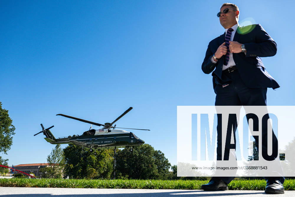 WASHINGTON, DC - OCT. 7: A Secret Service agent stands guard as Marine One, with United States President Donald J Trump aboard, departs the on the South Lawn of the White House in Washington, DC, USA, en route to a campaign rally in San Antonio, Texas on Wednesday