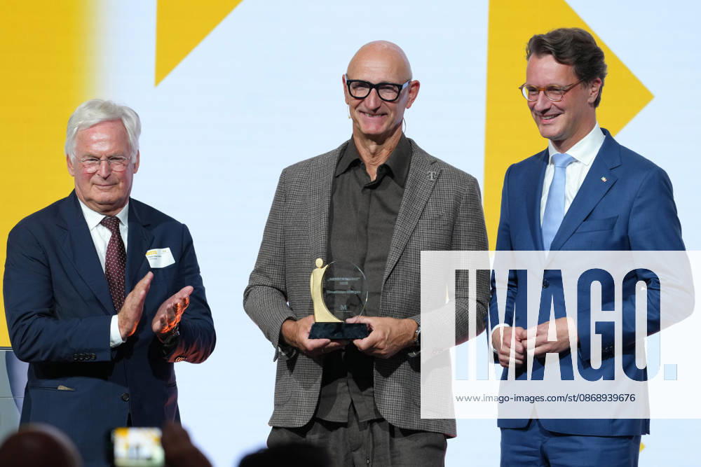 Brand Economy Day 2026: Franz Peter Falke on stage with Tim Hoettges, CEO of Telekom and winner of the Human Brand award, and Hendrik Wuest, Minister President of North Rhine-Westphalia, at Brand Economy Day 2026, Berlin, October 8, 2026, Berlin, Berlin, Germany