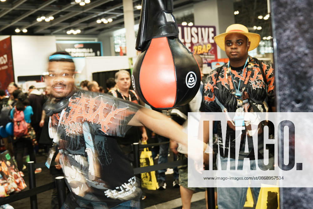An attendee swings at a punching bag at the 2026 New York Comic Con at the Javits Center on October 8, 2026 in New York. New York USA - ZUMAb148 20261008_zap_b148_067