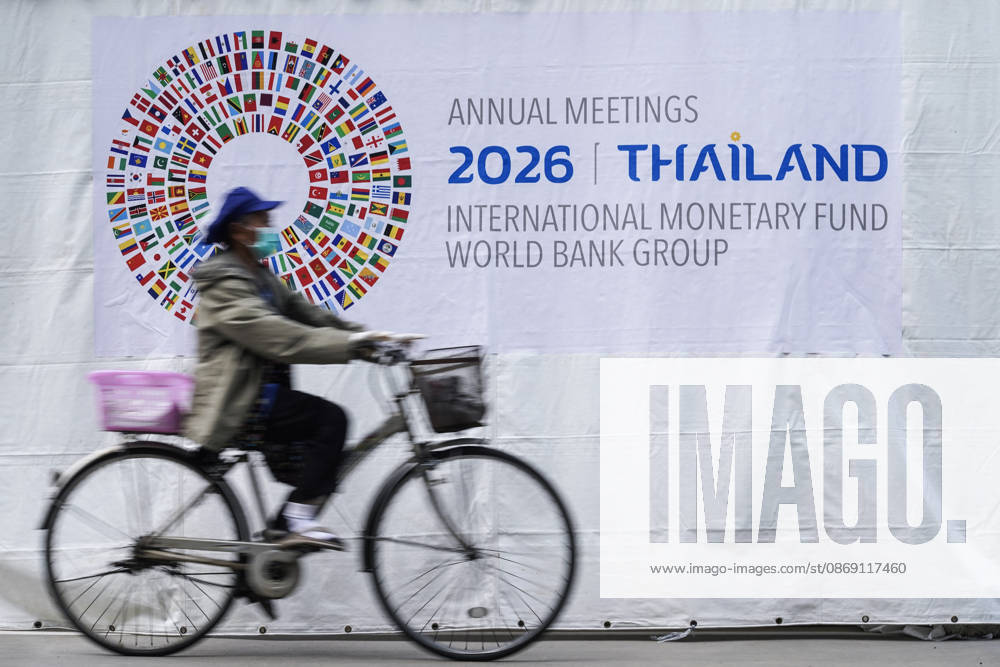 IMF World Bank 2026 Annual Meetings In Bangkok. A woman rides a bicycle past a banner ahead of the annual meetings of the International Monetary Fund (IMF) and the World Bank Group, at the Queen Sirikit National Convention Center in Bangkok, Thailand, on October 10, 2026. Bangkok Bangkok Thailand