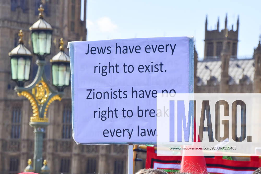 A protester on Westminster Bridge holds a sign stating Jews have every right to exist, Zionists have no right to break every law as thousands of people march in support of Palestine. The protesters also called on the government to stop arming Israel and for sanctions on Israel. London United Kingdom - ZUMAv130 20261010_zip_v130_035