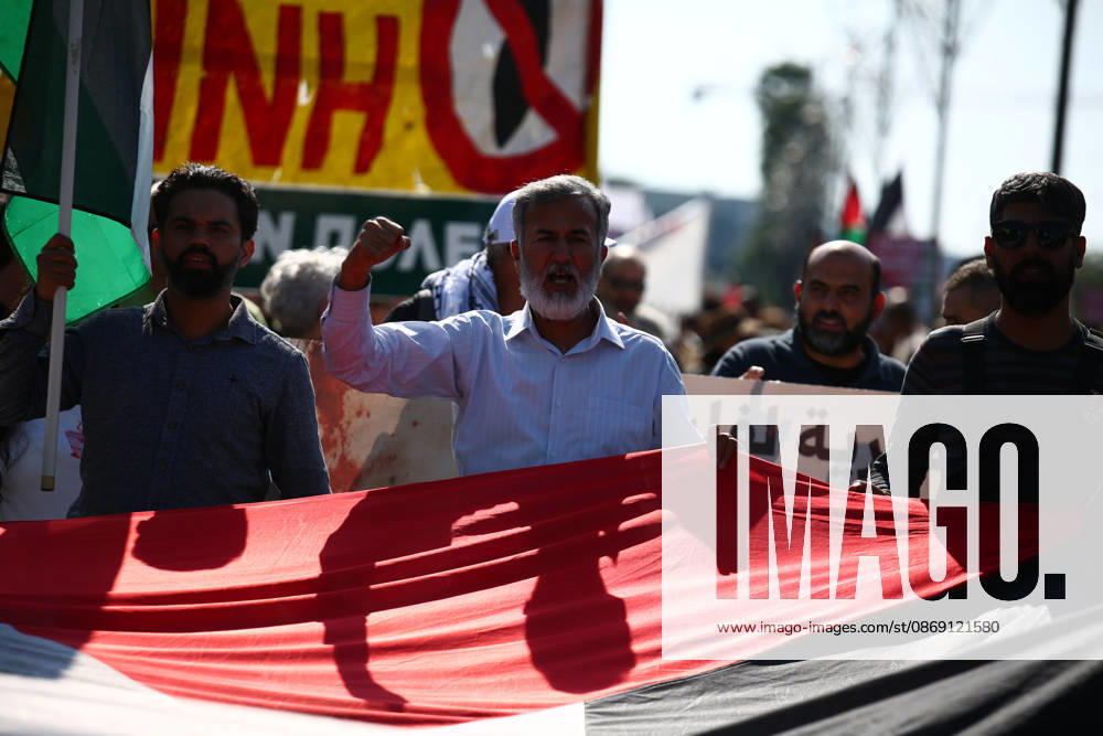 Protesters chant and raise their fists while carrying a large Palestinian flag during a pro-Palestinian march. Athens GREECE - ZUMAx103 20261010_zip_x103_007
