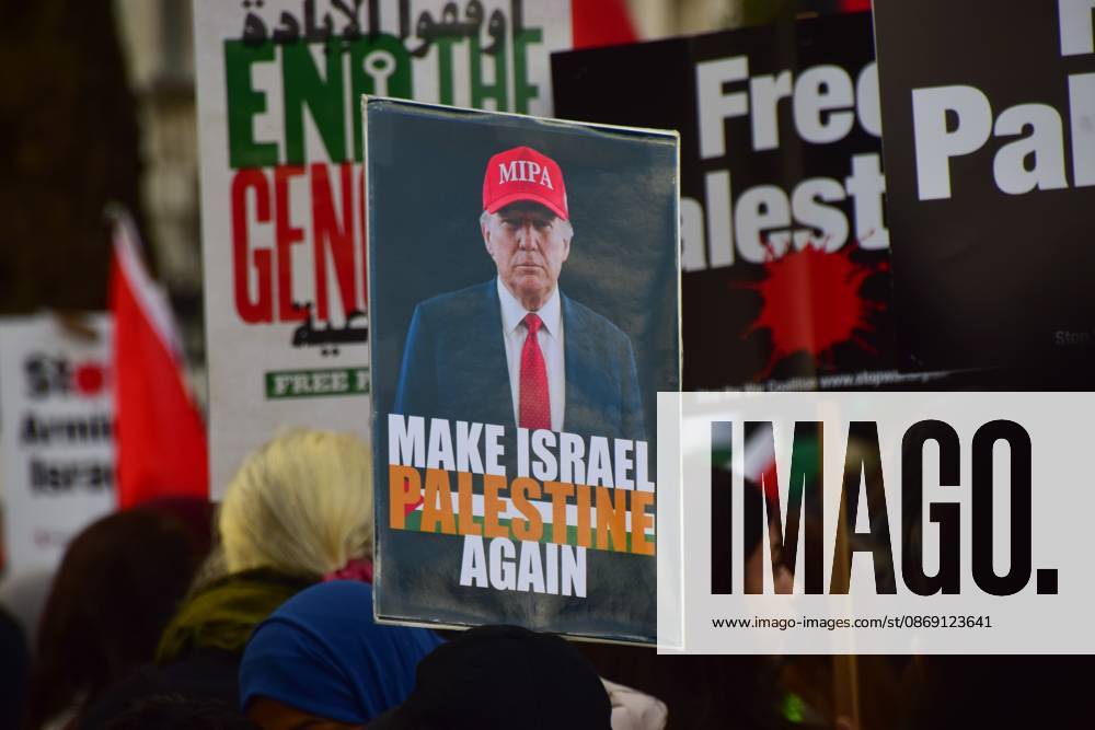 A protester holds a Make Israel Palestine Again placard depicting Donald Trump during the National March for Palestine..Thousands of people marched in Central London marking three years of what the protest organisers call the genocide against the Palestinian people in Gaza London United Kingdom - ZUMAs197 20261010_aaa_s197_173