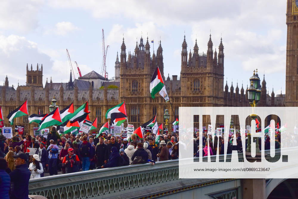 Protesters pass over Westminster Bridge past the Houses of Parliament during the National March for Palestine. Thousands of people marched in Central London marking three years of what the protest organisers call the genocide against the Palestinian people in Gaza London United Kingdom - ZUMAv130 20261010_zip_v130_073