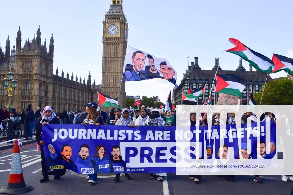 Protesters hold a Journalists are not targets banner on Westminster Bridge during the National March for Palestine..Thousands of people marched in Central London marking three years of what the protest organisers call the genocide against the Palestinian people in Gaza London United Kingdom - ZUMAs197 20261010_aaa_s197_186