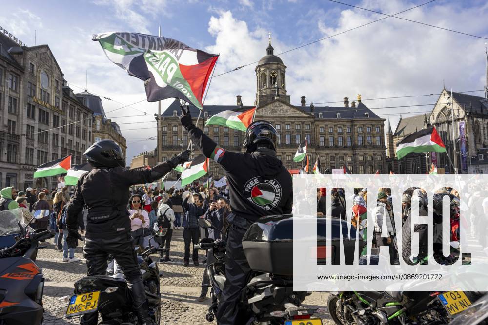 Amsterdam, Noord-Holland, The Netherlands: October 11, 2026, Amsterdam, Netherlands: Motorcyclists raise Palestinian flags during a pro-Palestinian protest at Dam Square, with the Royal Palace of Amsterdam in the background. Amsterdam The Netherlands - ZUMAl165 20261011_zip_l165_017