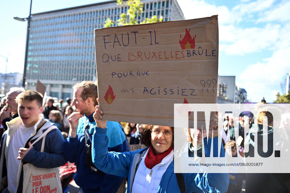 Tens of thousands march in Brussels demanding stronger climate action BRUSSELS, BELGIUM - OCTOBER 11: Demonstrators hold climate-themed placards as tens of thousands of people march through Brussels calling for stronger action against climate change and reduced dependence on fossil fuels, on October 11, 2026 in Brussels, Belgium. The protest was organized by the Belgian Climate Coalition, which brings together around 100 civil society organizations. Participants marched along major roads toward Schuman Square, home to several European Union institutions, while protesting the government s climate policies. Dursun Aydemir Anadolu Brussels Belgium. Editorial use only. Please get in touch for any other usage.