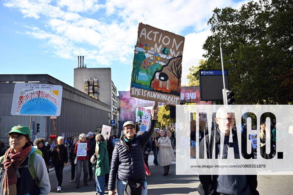 Tens of thousands march in Brussels demanding stronger climate action BRUSSELS, BELGIUM - OCTOBER 11: Demonstrators hold climate-themed placards as tens of thousands of people march through Brussels calling for stronger action against climate change and reduced dependence on fossil fuels, on October 11, 2026 in Brussels, Belgium. The protest was organized by the Belgian Climate Coalition, which brings together around 100 civil society organizations. Participants marched along major roads toward Schuman Square, home to several European Union institutions, while protesting the government s climate policies. Dursun Aydemir Anadolu Brussels Belgium. Editorial use only. Please get in touch for any other usage.