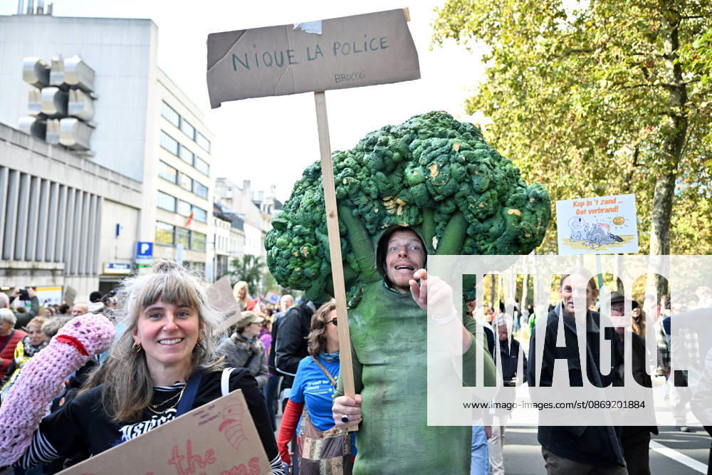 Tens of thousands march in Brussels demanding stronger climate action BRUSSELS, BELGIUM - OCTOBER 11: Demonstrators hold climate-themed placards as tens of thousands of people march through Brussels calling for stronger action against climate change and reduced dependence on fossil fuels, on October 11, 2026 in Brussels, Belgium. The protest was organized by the Belgian Climate Coalition, which brings together around 100 civil society organizations. Participants marched along major roads toward Schuman Square, home to several European Union institutions, while protesting the government s climate policies. Dursun Aydemir Anadolu Brussels Belgium. Editorial use only. Please get in touch for any other usage.