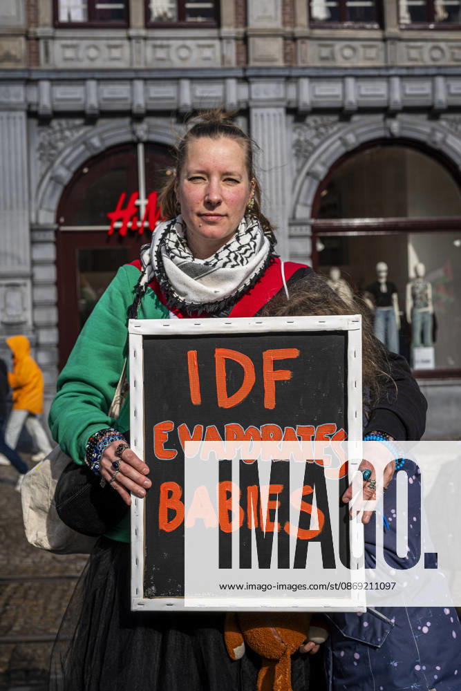 Amsterdam, North Holland, The Netherlands - Holland: 11 October 2026, Amsterdam, the Netherlands: A Protester holds a sign reading â€oeIDF Evaporates Babiesâ€Â. Protesters gathered at Dam Square for speeches and anti-war music before marching through Amsterdamâ€⠢s city centre in a demonstration dubbed â€oeThree Years of Genocideâ€Â. The event marked three years since the start of the Israelâ€Hamas war. Demonstrators carried Palestinian flags and banners, demanding the Dutch government act against what they describe as a genocide in Gaza. Amsterdam The Netherlands - Holland - ZUMAp202 20261011_zip_p202_004
