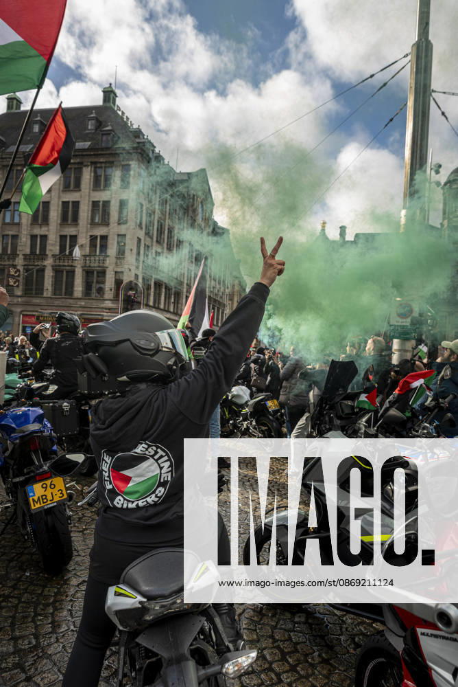 Amsterdam, North Holland, The Netherlands - Holland: 11 October 2026, Amsterdam, the Netherlands: Bikers for Palestine members set off smoke flares at Dam Square. Protesters gathered at Dam Square for speeches and anti-war music before marching through Amsterdamâ€⠢s city centre in a demonstration dubbed â€oeThree Years of Genocideâ€Â. The event marked three years since the start of the Israelâ€Hamas war. Demonstrators carried Palestinian flags and banners, demanding the Dutch government act against what they describe as a genocide in Gaza. Amsterdam The Netherlands - Holland - ZUMAp202 20261011_zip_p202_010