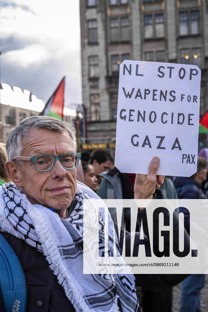 Amsterdam, North Holland, The Netherlands - Holland: 11 October 2026, Amsterdam, the Netherlands: A Protester holds a sign reading â€oeNL Stop Weapons for Genocide Gaza†(translated from Dutch). Protesters gathered at Dam Square for speeches and anti-war music before marching through Amsterdamâ€⠢s city centre in a demonstration dubbed â€oeThree Years of Genocideâ€Â. The event marked three years since the start of the Israelâ€Hamas war. Demonstrators carried Palestinian flags and banners, demanding the Dutch government act against what they describe as a genocide in Gaza. Amsterdam The Netherlands - Holland - ZUMAp202 20261011_zip_p202_014