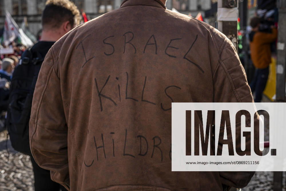Amsterdam, North Holland, The Netherlands - Holland: 11 October 2026, Amsterdam, the Netherlands: A protester wears a jacket baring the words Ã¢â‚¬oeIsrael Kills Children.Ã¢â‚¬Â Protesters gathered at Dam Square for speeches and anti-war music before marching through AmsterdamÃ¢â‚¬â ¢s city centre in a demonstration dubbed Ã¢â‚¬oeThree Years of GenocideÃ¢â‚¬Â. The event marked three years since the start of the IsraelÃ¢â‚¬Hamas war. Demonstrators carried Palestinian flags and banners, demanding the Dutch government act against what they describe as a genocide in Gaza. Amsterdam The Netherlands - Holland - ZUMAp202 20261011_zip_p202_017