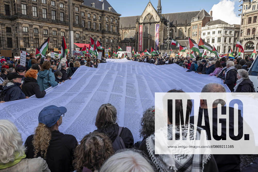 Amsterdam, North Holland, The Netherlands - Holland: 11 October 2026, Amsterdam, the Netherlands: Protesters hold a banner baring the names of thousands of people killed in Gaza. Protesters gathered at Dam Square for speeches and anti-war music before marching through AmsterdamÃ¢â‚¬â ¢s city centre in a demonstration dubbed Ã¢â‚¬oeThree Years of GenocideÃ¢â‚¬Â. The event marked three years since the start of the IsraelÃ¢â‚¬Hamas war. Demonstrators carried Palestinian flags and banners, demanding the Dutch government act against what they describe as a genocide in Gaza. Amsterdam The Netherlands - Holland - ZUMAp202 20261011_zip_p202_019