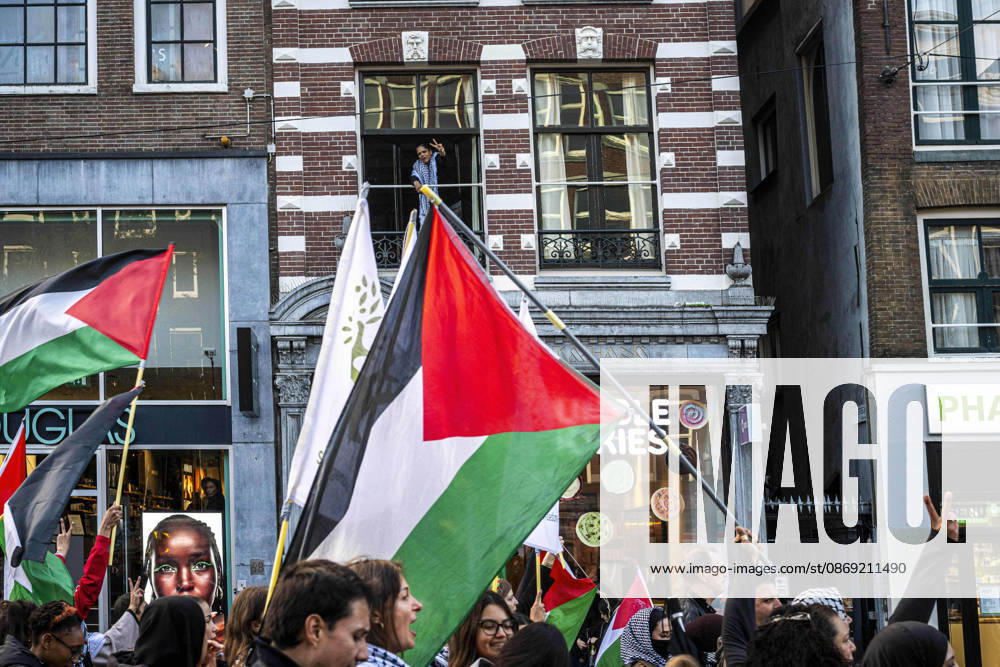 Amsterdam, North Holland, The Netherlands - Holland: 11 October 2026, Amsterdam, the Netherlands: A spectator gives a peace sign to marching pro-Palestinian demonstrators. Protesters gathered at Dam Square for speeches and anti-war music before marching through AmsterdamÃ¢â‚¬â ¢s city centre in a demonstration dubbed Ã¢â‚¬oeThree Years of GenocideÃ¢â‚¬Â. The event marked three years since the start of the IsraelÃ¢â‚¬Hamas war. Demonstrators carried Palestinian flags and banners, demanding the Dutch government act against what they describe as a genocide in Gaza. Amsterdam The Netherlands - Holland - ZUMAp202 20261011_zip_p202_026