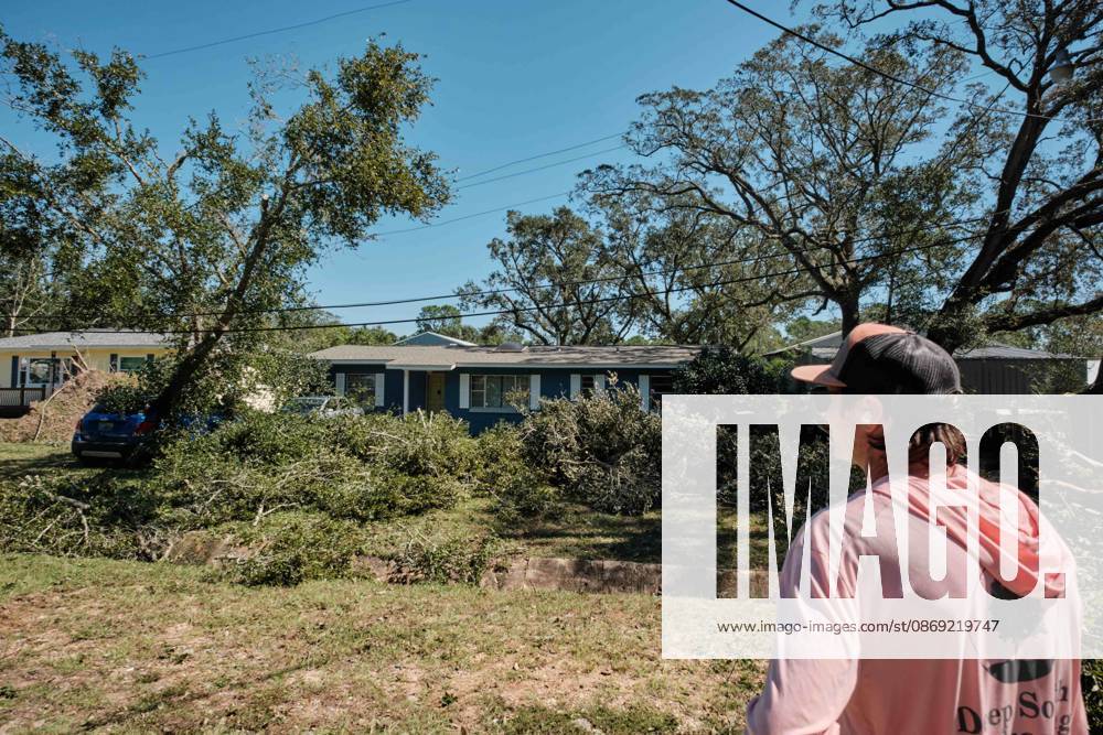 Pensacola, Florida, U.S: October 11, 2026 Pensacola, Florida USA: Jesse Roper of Deep South Landscaping looks at a yard full of fallen debris and branches after the arrival of Hurricane Isaias. Pensacola U.S - ZUMAa14_ 20261011_zaf_a14_022