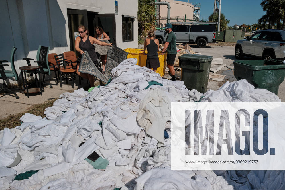 Pensacola Beach, Florida, U.S: October 11, 2026 Pensacola Beach, Florida USA: People clear out bed sheets and towels from the storm damaged building for Paradise Beach and Homes after the arrival of Hurricane Isaias. Pensacola Beach U.S - ZUMAa14_ 20261011_zaf_a14_026