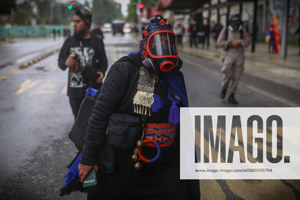 Hundreds of people protest against Columbus Day in Santiago SANTIAGO, CHILE - OCTOBER 12: A Mapuche protester wears a gas mask during the traditional protest against Columbus Day in Santiago, Chile, on October 12, 2026. Protesters demanded Indigenous rights and territorial recognition. Lucas Aguayo Araos Anadolu Santiago Chile. Editorial use only. Please get in touch for any other usage.