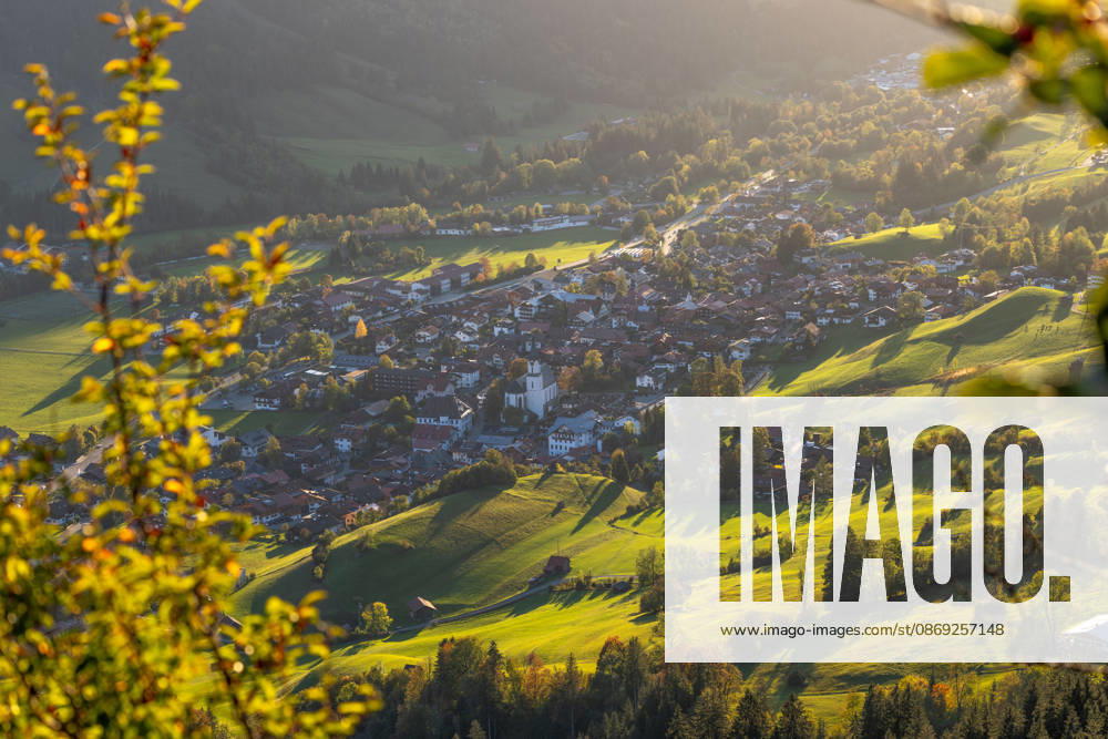 Autumn Evening in the Allgäu: The evening sun shines on the autumn landscape featuring the town of Bad Hindelang, Bad Hindelang, Bavaria, Germany
