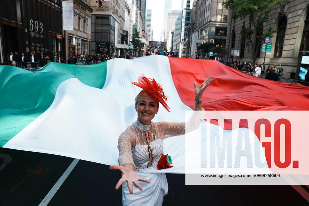 A woman holds an Italian flag at the 82nd Annual Columbus Day Parade up Fifth Avenue on October 12, 2026 in New York. This year s celebration commemorates 250 Years of Italian Contribution to America, honoring the generations who helped shape the nation and the vibrant community that continues to carry their legacy forward. New York USA - ZUMAb148 20261012_zap_b148_034