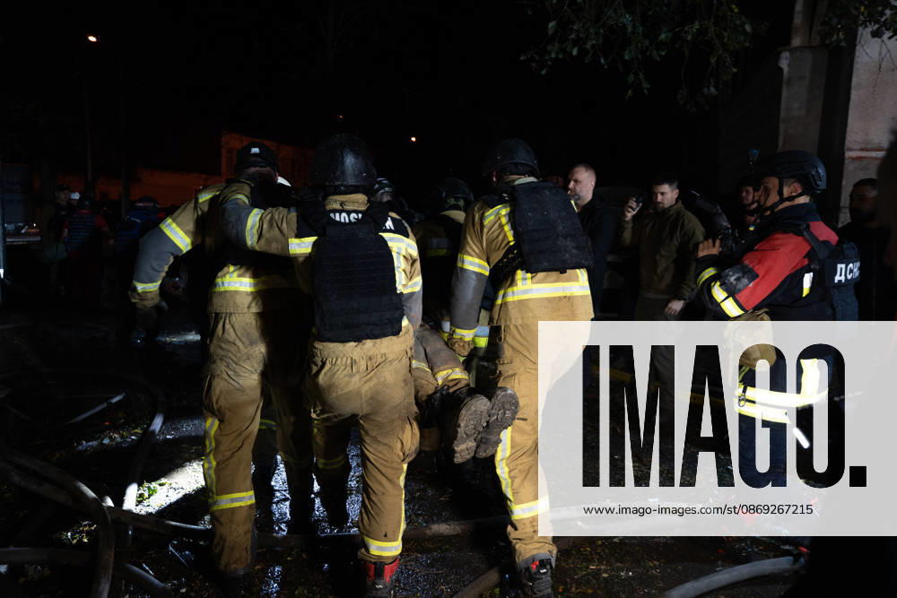 Rescuers load an injured firefighter into an ambulance after a sustained injury clearing debris at a Russian cruise missile strike on a residential area in Kharkiv, Ukraine, 2026. Kharkiv Ukraine - ZUMAm350 20261012_zip_m350_005